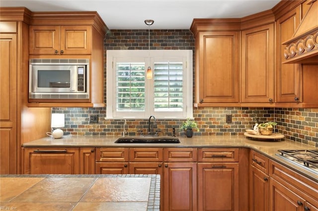 1276 Hebden Cv, Virginia Beach, VA 23452 - kitchen featuring appliances with stainless steel finishes, a sink, backsplash, and brown cabinetry