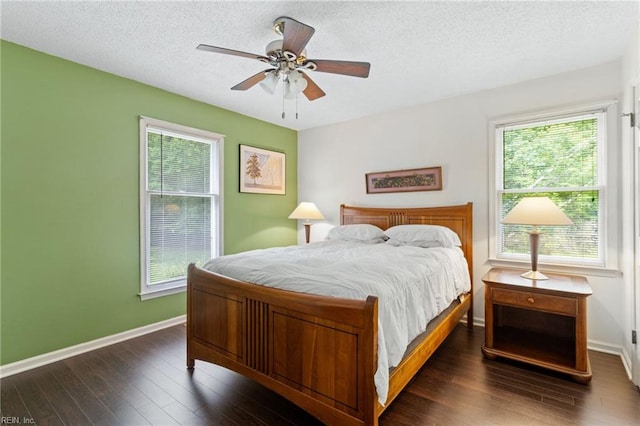 bedroom featuring dark wood-style floors, baseboards, a textured ceiling, and ceiling fan