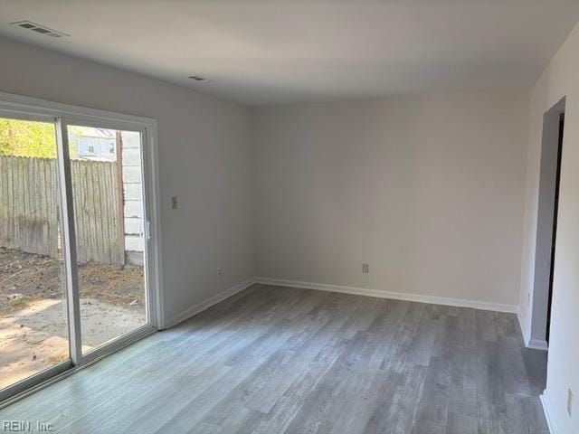 empty room featuring wood finished floors and baseboards