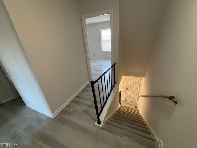stairs with wood finished floors and baseboards