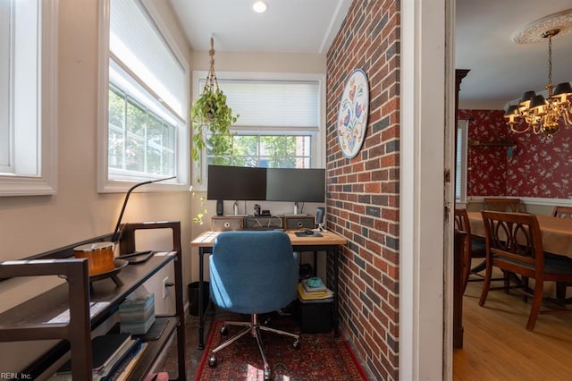 office featuring a chandelier, wallpapered walls, and wainscoting
