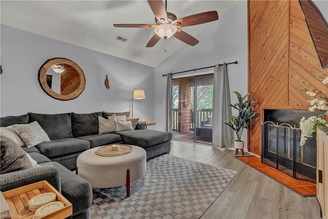 3032 Cape Henry Ct, Virginia Beach, VA 23451 - living room featuring a ceiling fan, a glass covered fireplace, wood finished floors, and high vaulted ceiling