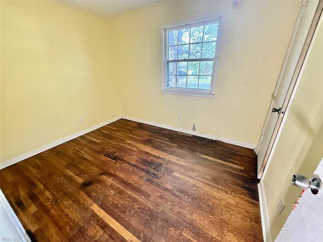 unfurnished bedroom featuring dark wood-style floors and baseboards