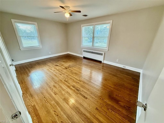 3900 Gosnold Ave, Norfolk, VA 23508 - empty room featuring radiator, plenty of natural light, ceiling fan, and wood finished floors