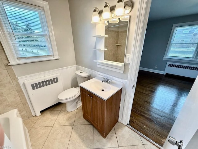 3900 Gosnold Ave, Norfolk, VA 23508 - bathroom with radiator, wainscoting, tile patterned flooring, toilet, and vanity