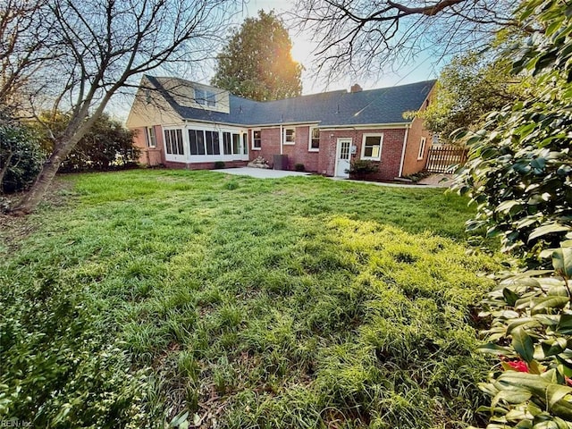 3900 Gosnold Ave, Norfolk, VA 23508 - rear view of property featuring brick siding, a patio, a sunroom, a chimney, and roof with shingles