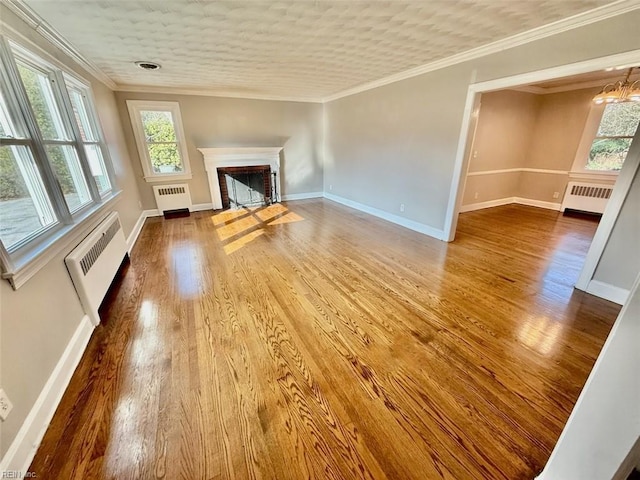 3900 Gosnold Ave, Norfolk, VA 23508 - unfurnished living room with radiator, wood finished floors, a fireplace, and crown molding