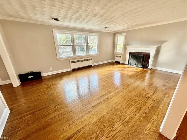 3900 Gosnold Ave, Norfolk, VA 23508 - unfurnished living room with radiator, ornamental molding, wood finished floors, a fireplace, and baseboards