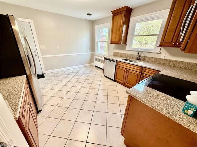 3900 Gosnold Ave, Norfolk, VA 23508 - kitchen with dishwasher, a sink, freestanding refrigerator, radiator, and light tile patterned flooring