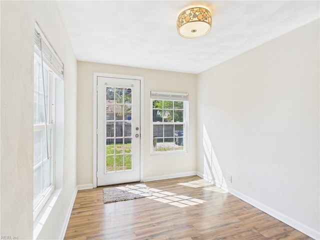 entryway featuring wood finished floors and baseboards