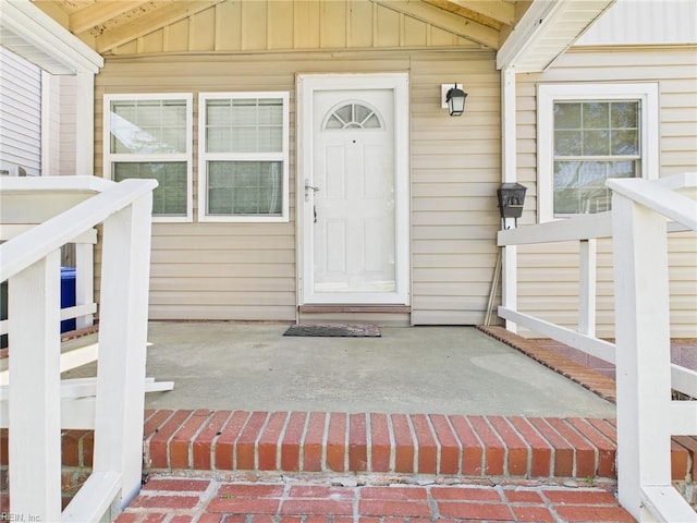 entrance to property featuring board and batten siding and a porch