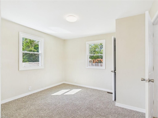 empty room with carpet and baseboards