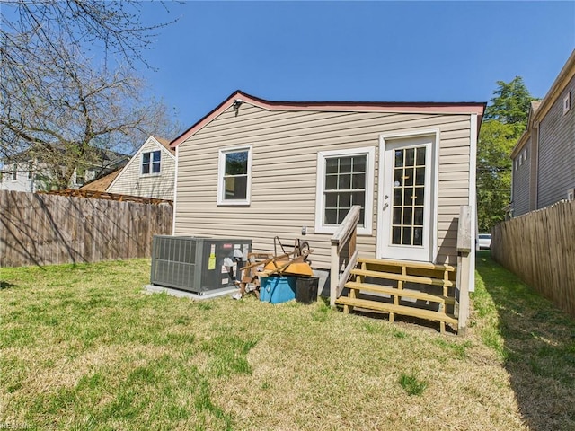 rear view of house with central AC unit and entry steps