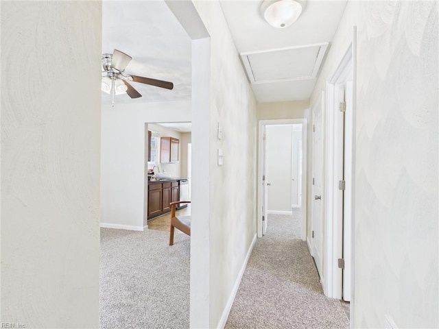 hall featuring carpet and baseboards
