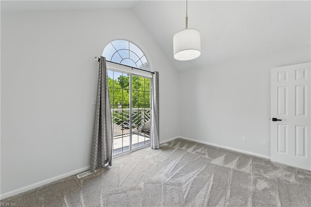 unfurnished room with carpet, vaulted ceiling, and baseboards