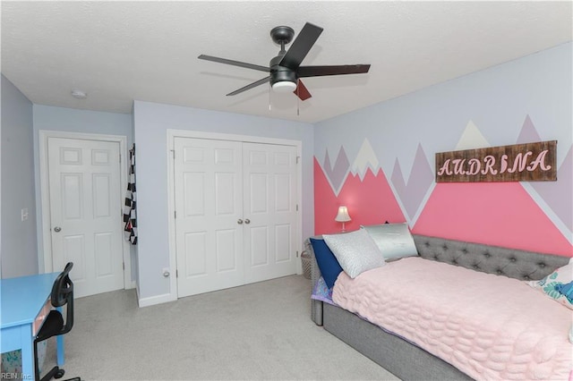 bedroom with a closet, carpet, ceiling fan, and baseboards