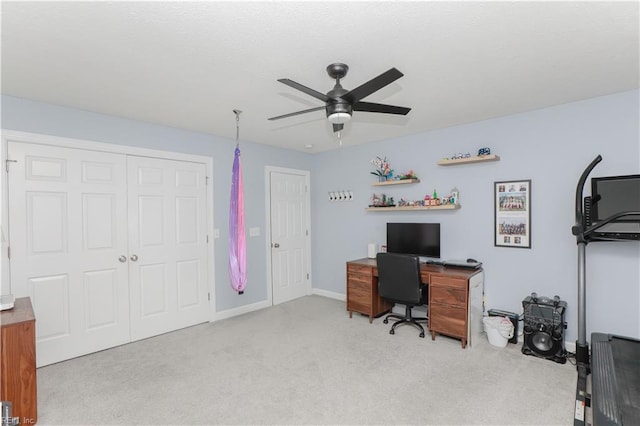 carpeted home office with a ceiling fan
