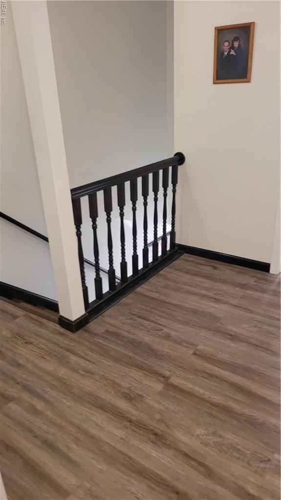 stairs featuring wood finished floors and baseboards