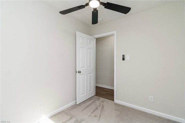 spare room with baseboards, carpet floors, and a ceiling fan
