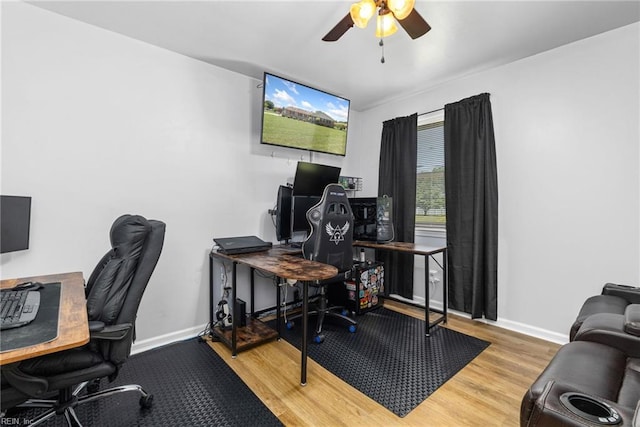 home office with ceiling fan, wood finished floors, and baseboards