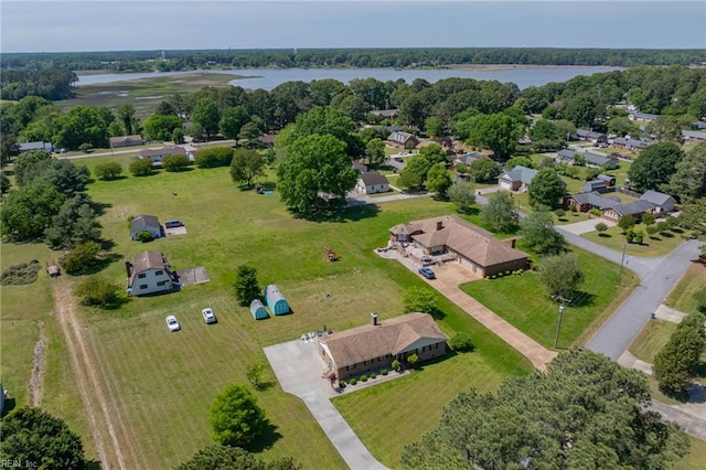 aerial view of a nearby body of water and a tree filled landscape