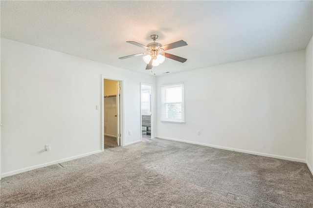 unfurnished room with a ceiling fan, carpet flooring, and baseboards