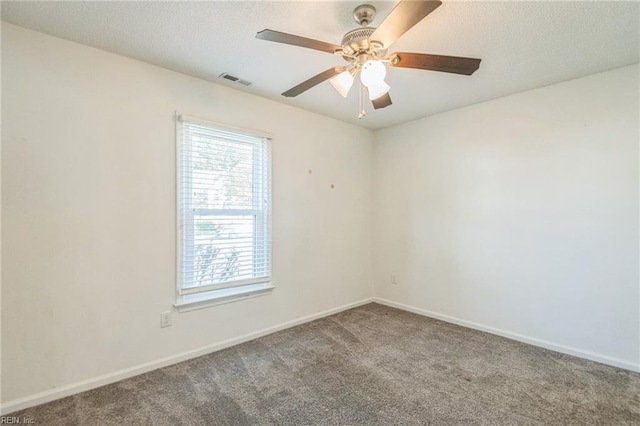 unfurnished room featuring carpet flooring, baseboards, and ceiling fan