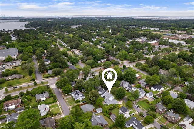 aerial view of property and surrounding area featuring a large body of water, a notable bridge, and nearby suburban area