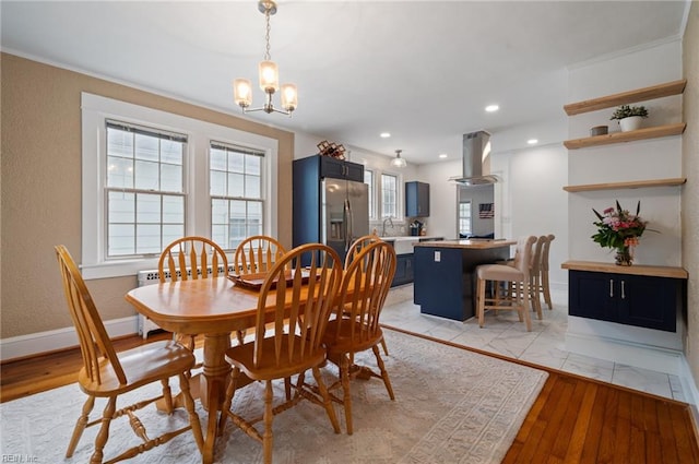 dining room featuring a chandelier, light wood-style floors, recessed lighting, and baseboards
