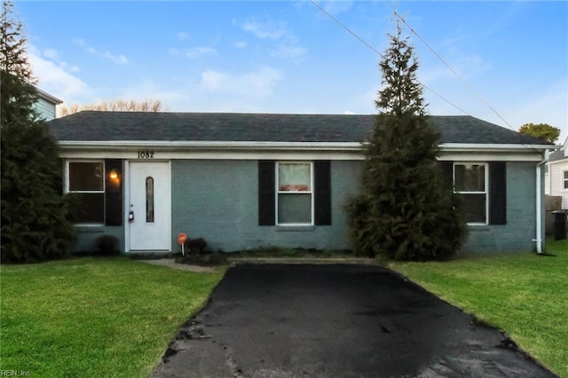 ranch-style home with a front lawn