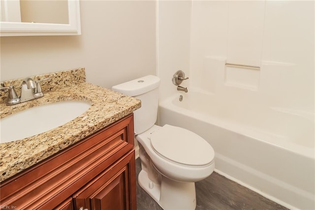 bathroom with toilet, vanity, shower / bathtub combination, and wood finished floors