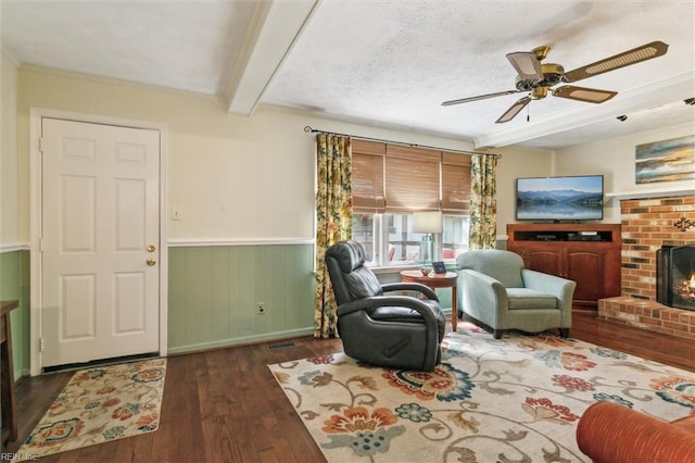 16 Windy Point Dr, Poquoson, VA 23662 - living room with hardwood / wood-style flooring, a brick fireplace, beam ceiling, a wainscoted wall, and a ceiling fan