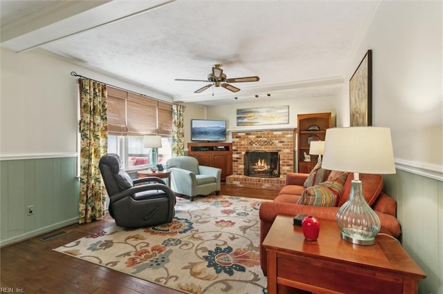 16 Windy Point Dr, Poquoson, VA 23662 - living room featuring ceiling fan, wood-type flooring, wainscoting, and a brick fireplace