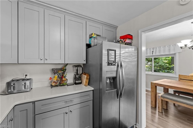 3701 Edinburgh Dr, Virginia Beach, VA 23452 - kitchen featuring stainless steel fridge, gray cabinetry, light countertops, and light wood-type flooring