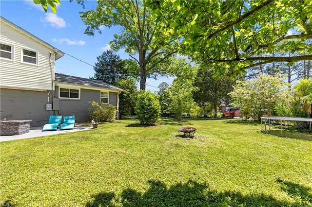 3701 Edinburgh Dr, Virginia Beach, VA 23452 - view of green lawn with an outdoor fire pit, a trampoline, and a patio area