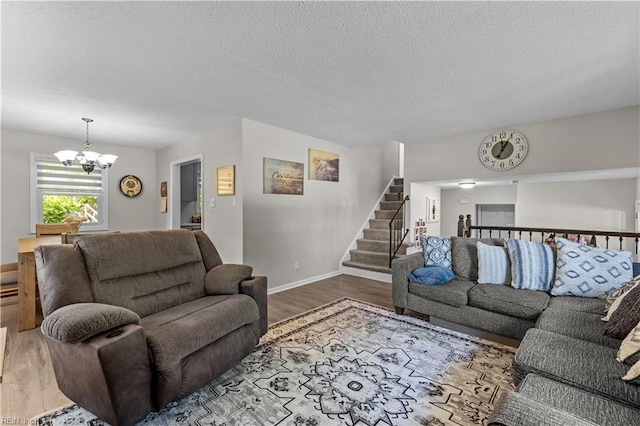 3701 Edinburgh Dr, Virginia Beach, VA 23452 - living room featuring wood finished floors, a chandelier, a textured ceiling, stairway, and baseboards
