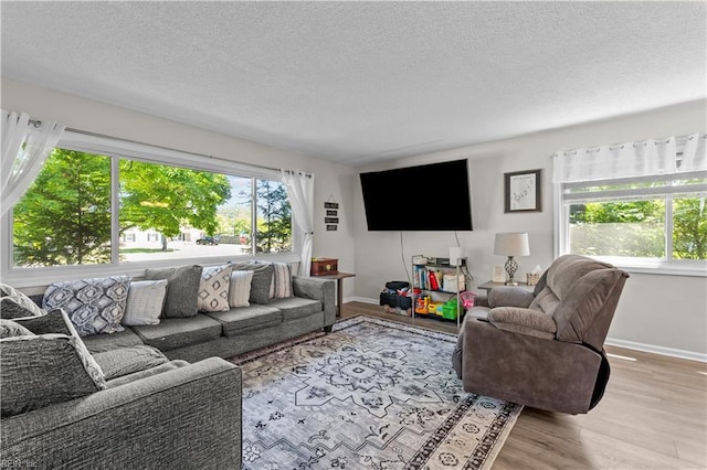 3701 Edinburgh Dr, Virginia Beach, VA 23452 - living room featuring a textured ceiling, wood finished floors, and baseboards