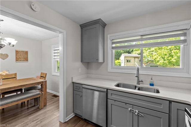 3701 Edinburgh Dr, Virginia Beach, VA 23452 - kitchen with stainless steel dishwasher, gray cabinets, a sink, wood finished floors, and light countertops