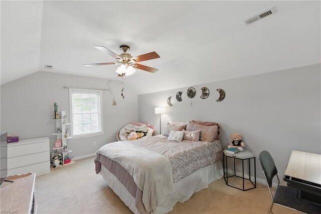bedroom with light carpet, vaulted ceiling, baseboards, and a ceiling fan