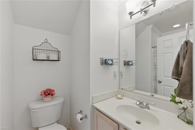 full bath featuring toilet, vanity, and crown molding