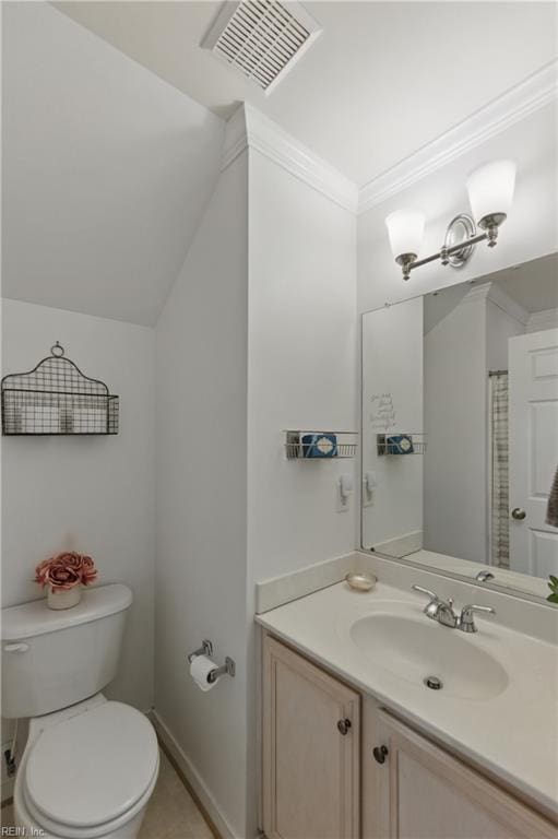 bathroom featuring toilet, vanity, and ornamental molding