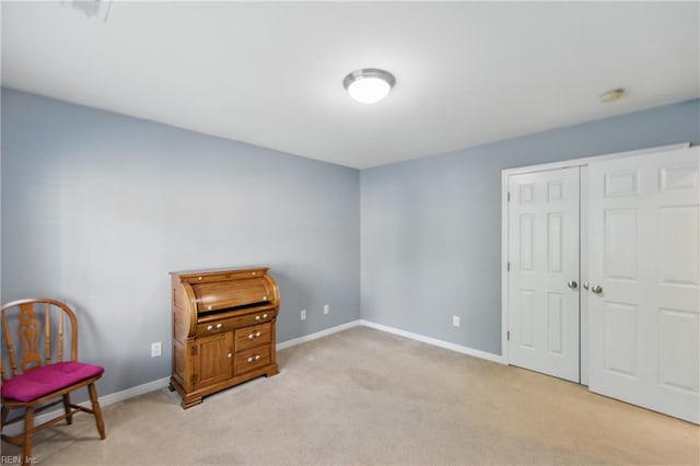 bedroom featuring light carpet, a closet, and baseboards