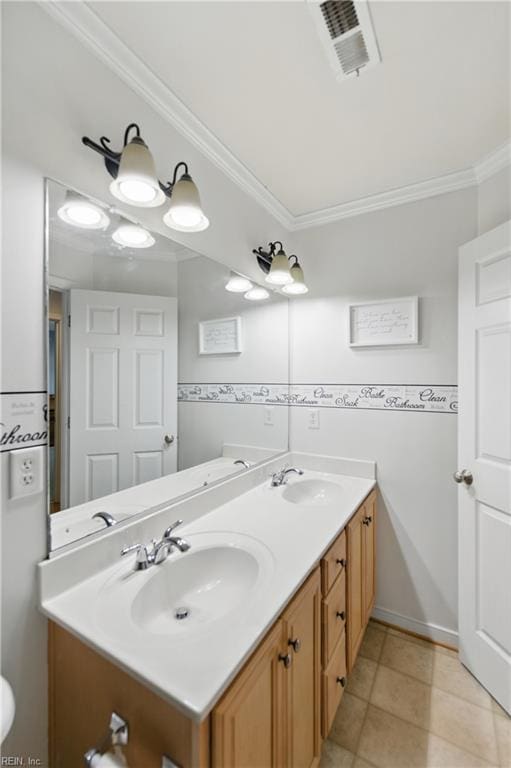 full bath featuring double vanity, ornamental molding, and tile patterned flooring