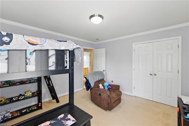 carpeted bedroom featuring ornamental molding, a closet, and baseboards