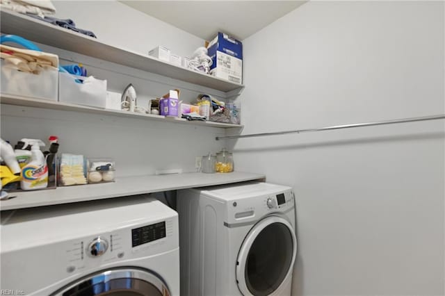clothes washing area with washing machine and clothes dryer