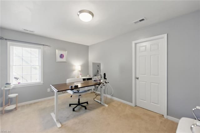 office with light carpet and baseboards
