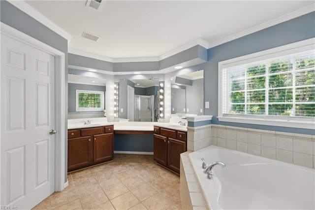 full bath with a stall shower, tile patterned floors, two vanities, a garden tub, and ornamental molding