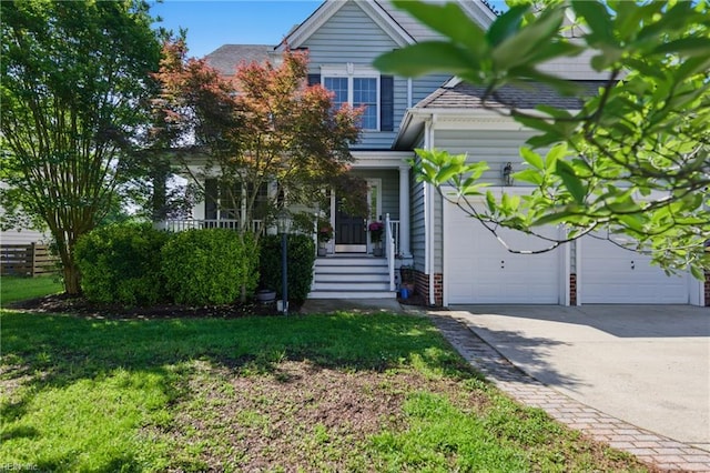 view of front of home with driveway, a garage, and a front yard