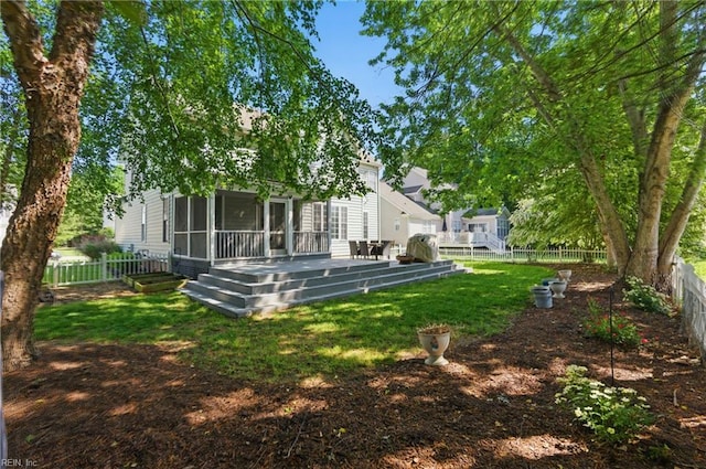 view of yard with a sunroom and a deck