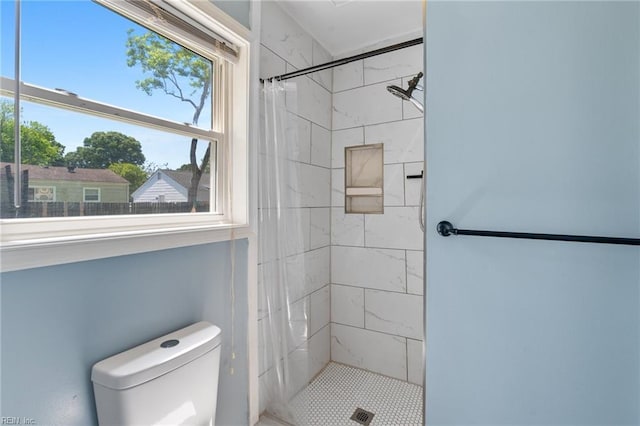 full bathroom with a stall shower and toilet